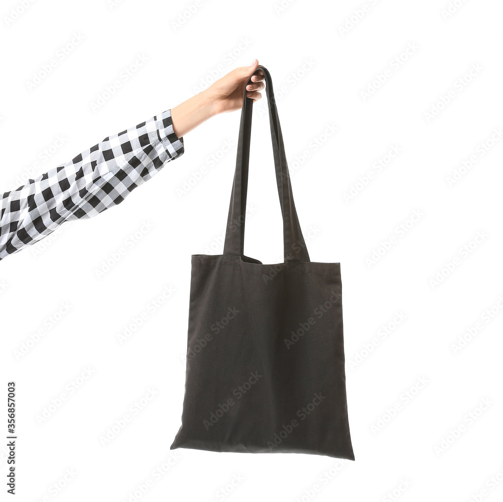 Female hand with eco bag on white background