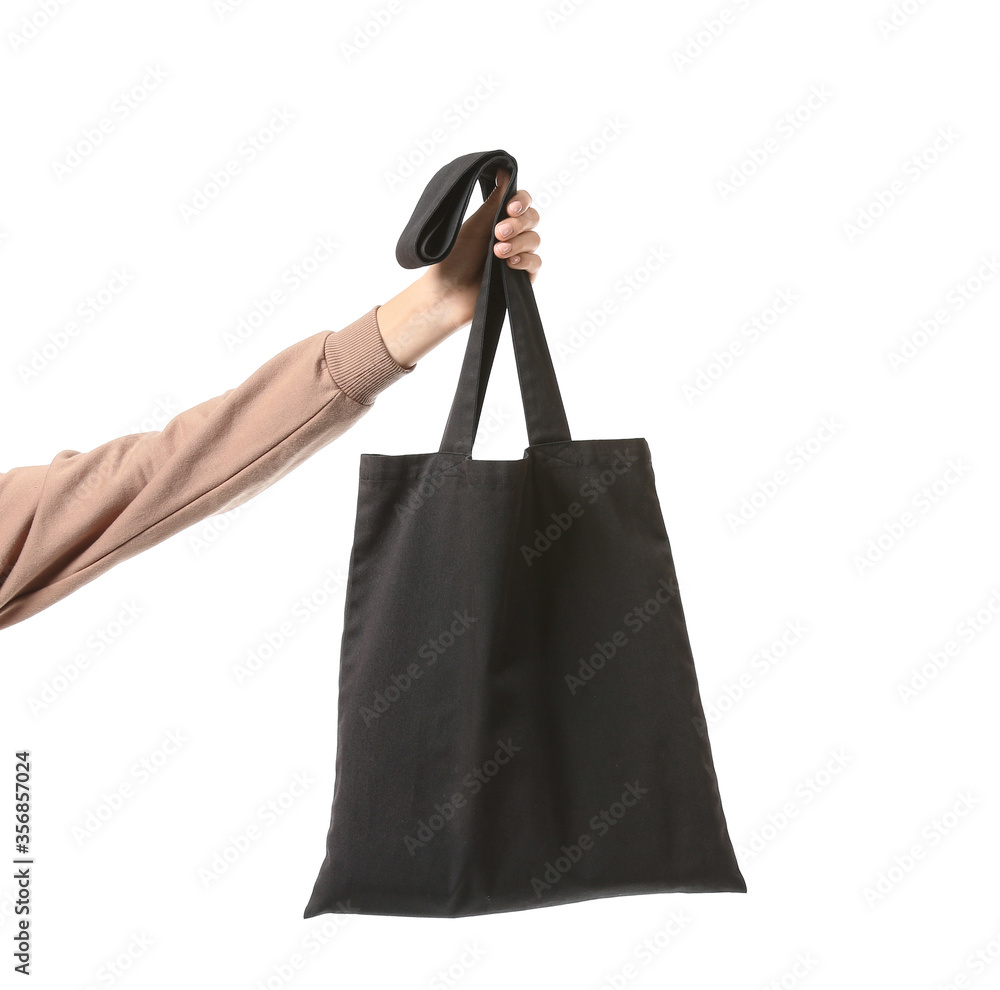 Female hand with eco bag on white background