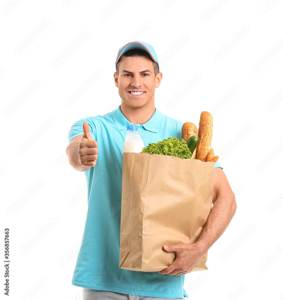 Delivery man with food in bag showing thumb-up gesture on white background