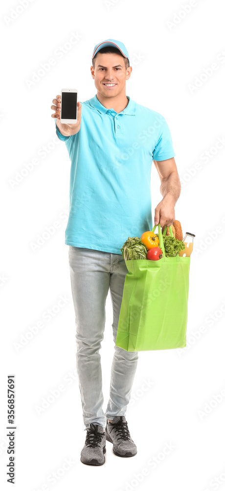 Delivery man with food in bag and mobile phone on white background