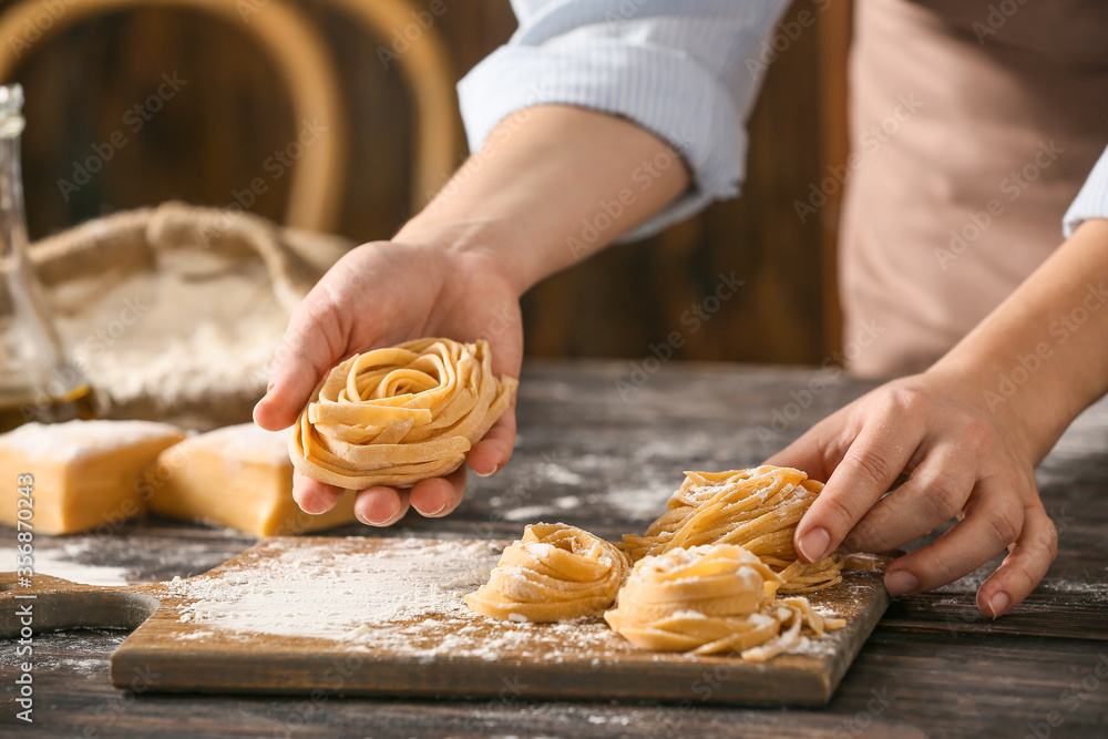 Woman preparing pasta in kitchen, closeup