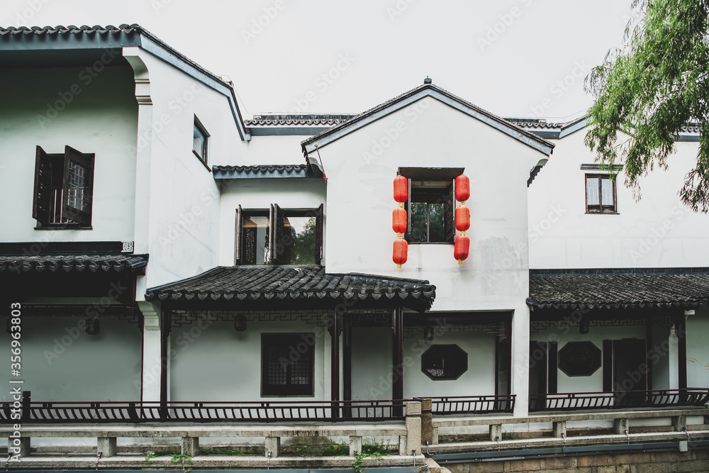 Old house with white walls and grey tiles