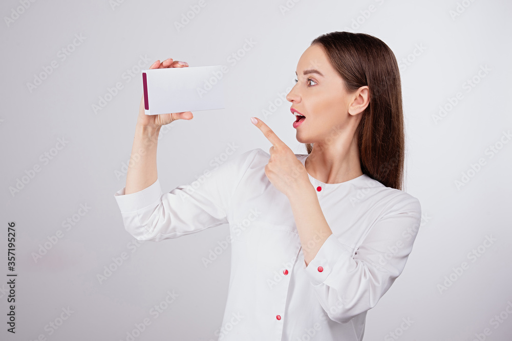 emotions of surprise, beautiful young girl with natural makeup and  beautiful face shows  finger on 