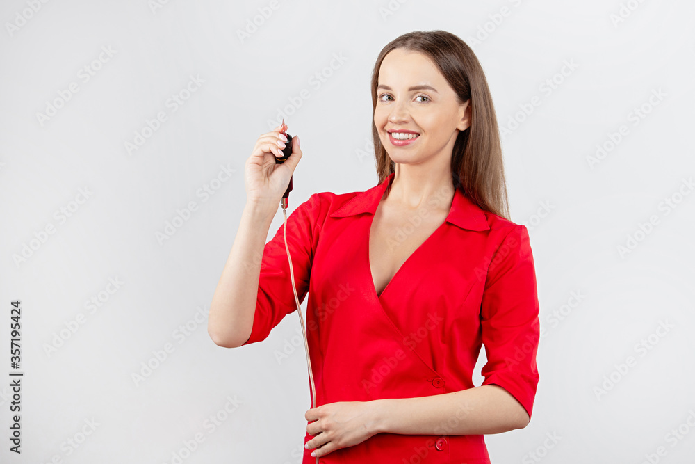 girl in red clothes holds  tool for permanent makeup,  portrait of  girl with  smile, màster on  gra