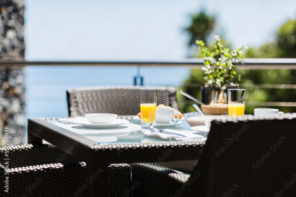 Breakfast on luxury patio dining table overlooking ocean