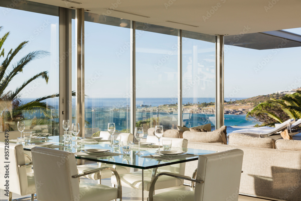 Set table in modern dining room overlooking ocean