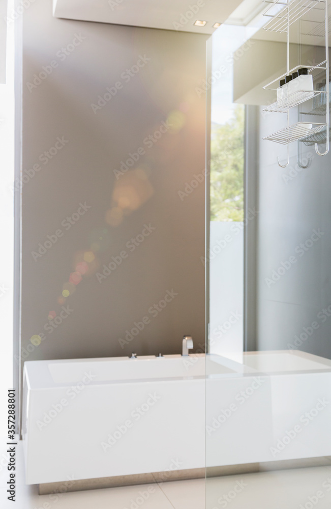 Bathtub and glass wall in modern bathroom