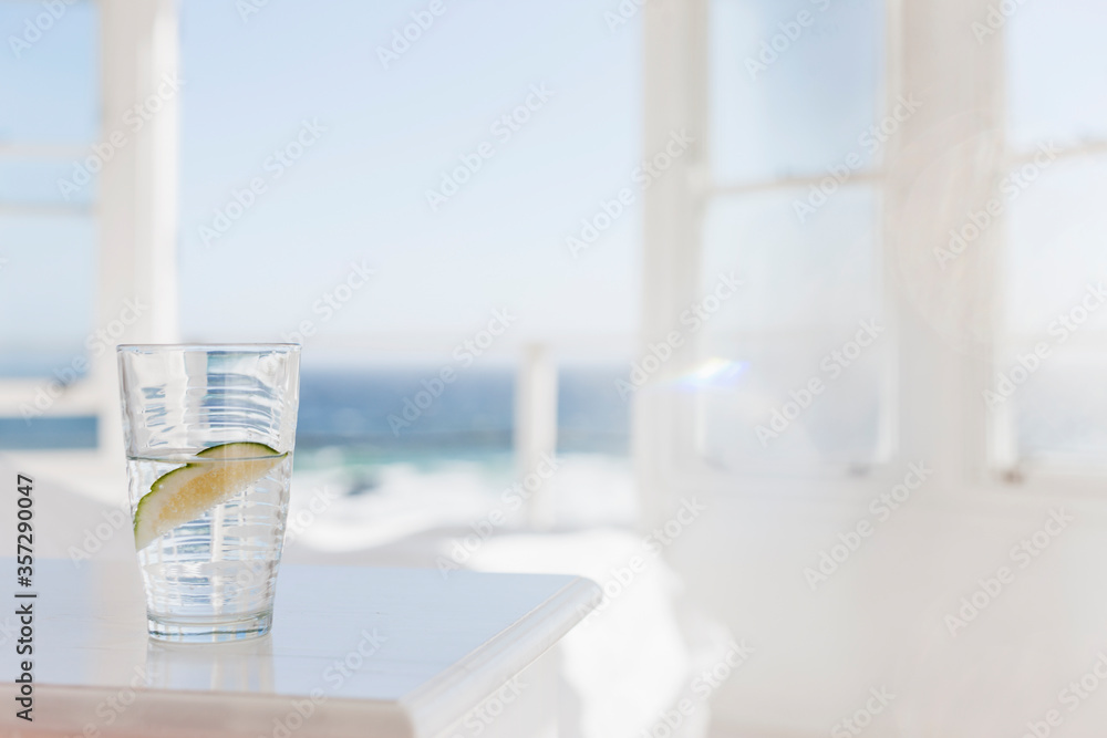 Glass of water with lime on table