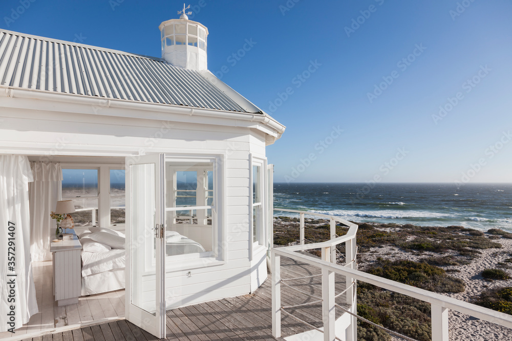 White bedroom overlooking ocean