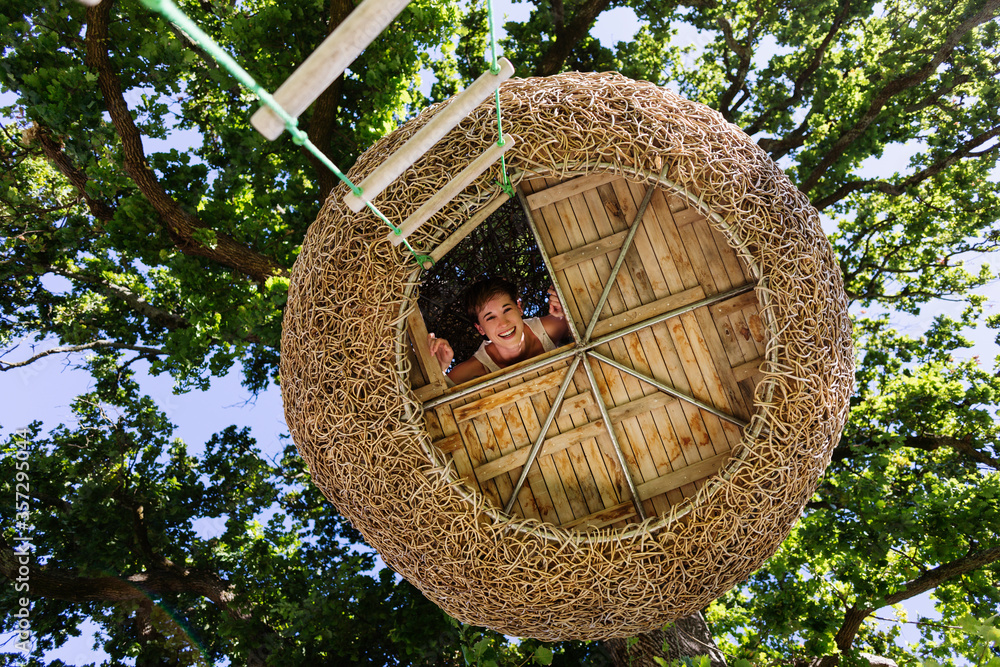 Woman smiling in modern treehouse