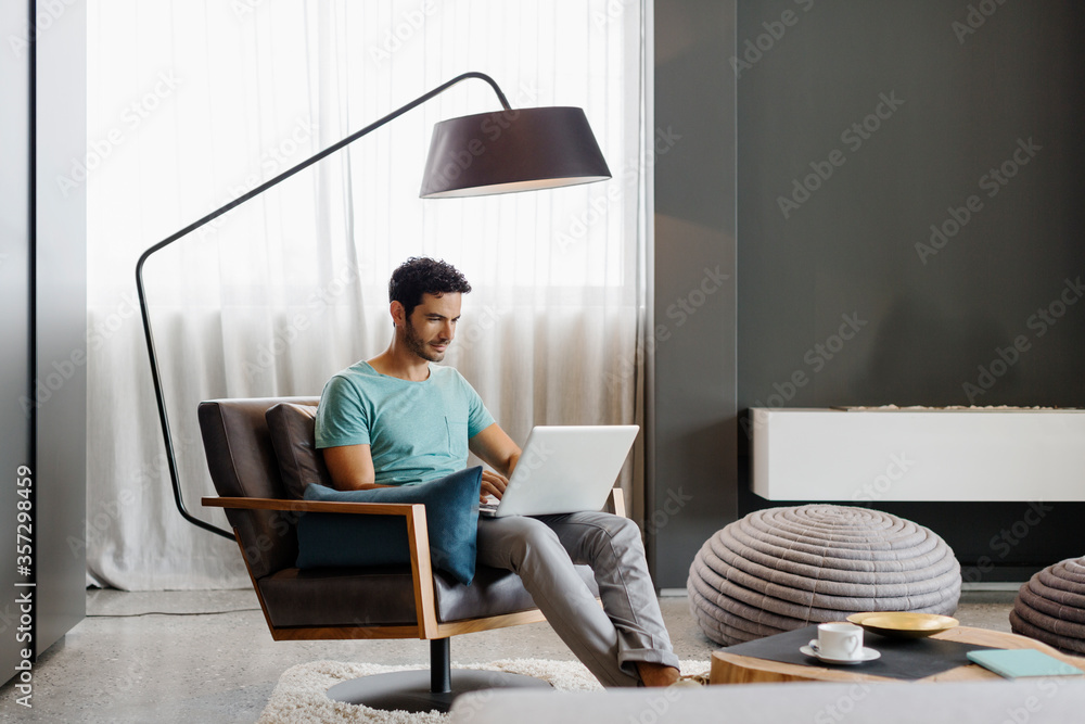 Man using laptop in living room