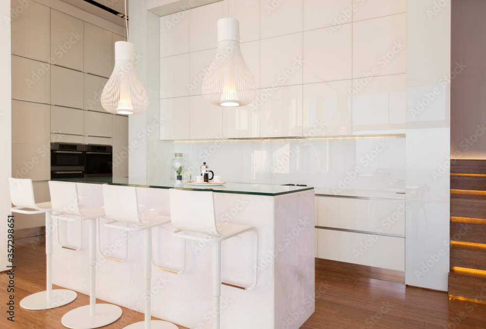 Bar stools at counter in modern kitchen