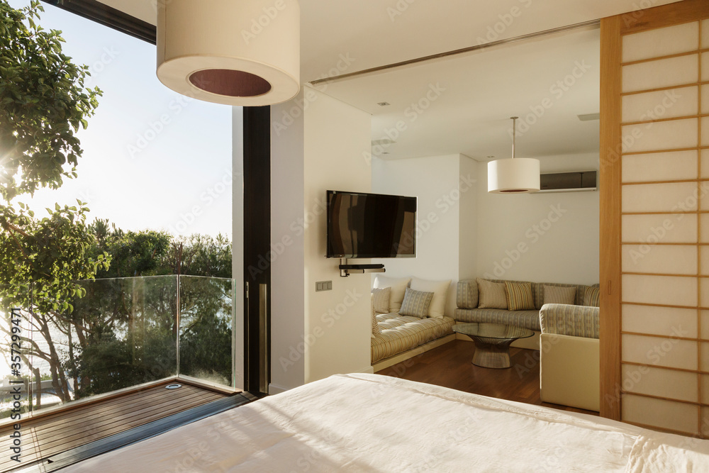 Sunny bedroom with balcony