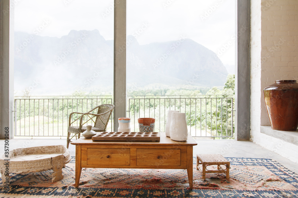 Coffee table in living room overlooking landscape