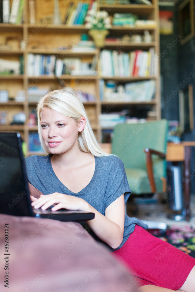 Woman using laptop in living room