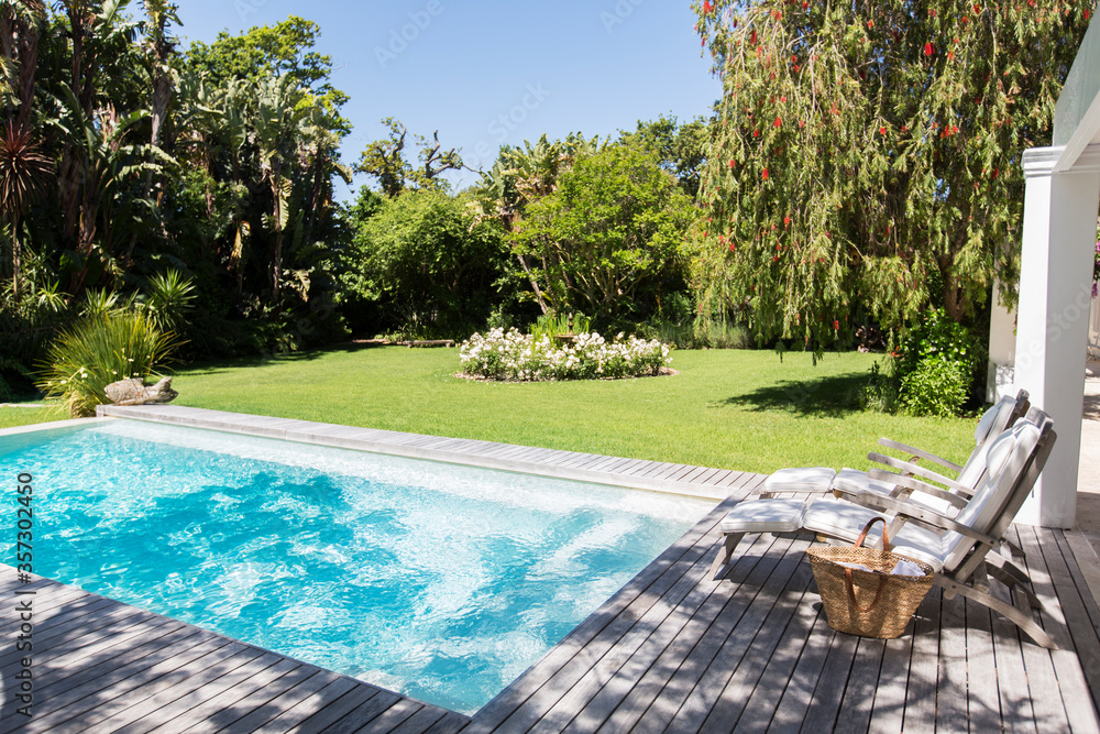 Lawn chairs overlooking backyard and swimming pool