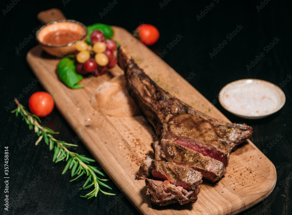 sliced ​​grilled beef steak tomahawk on a board, medium rare