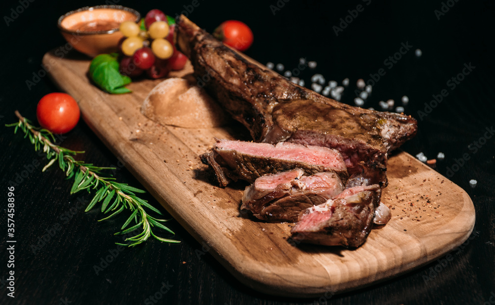 sliced ​​grilled beef steak tomahawk on a board, medium rare