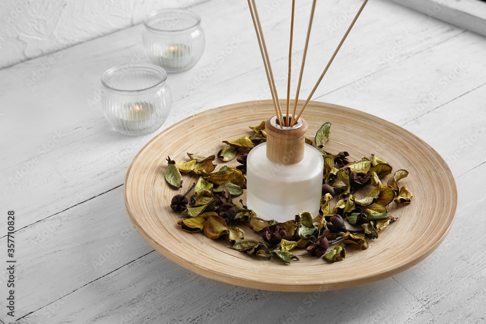 Herbal reed diffuser on table in room