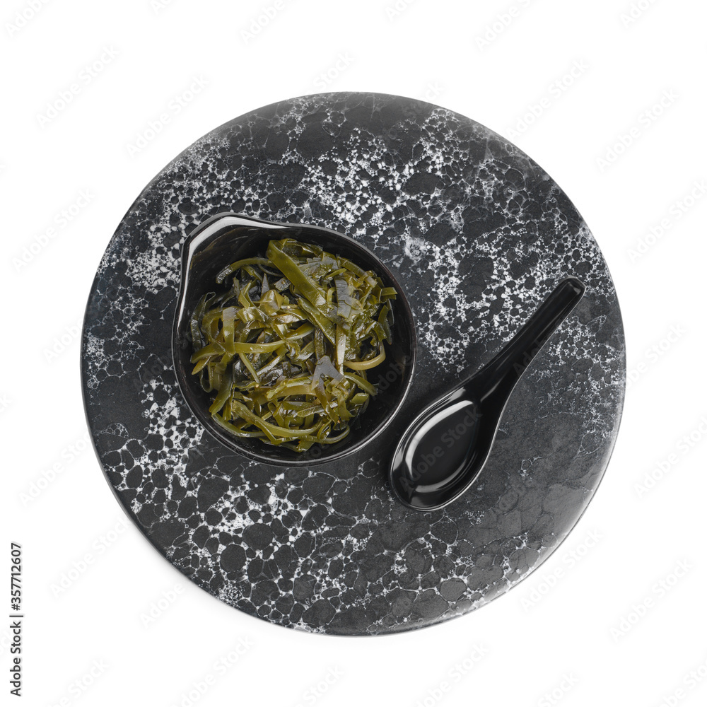 Bowl with tasty seaweed and sauce on white background