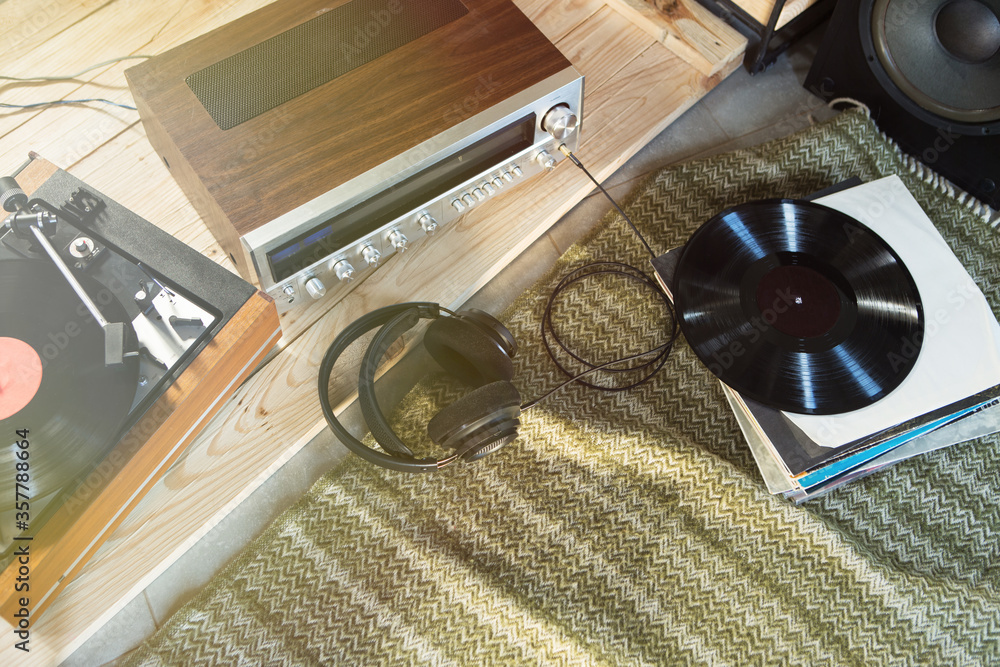 HiFi system with turntable, amplifier, headphones and lp vinyl records in a listening room