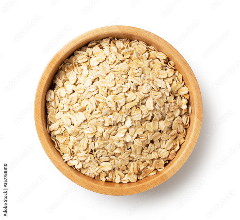 Oatmeal in a wooden bowl set against a white background.