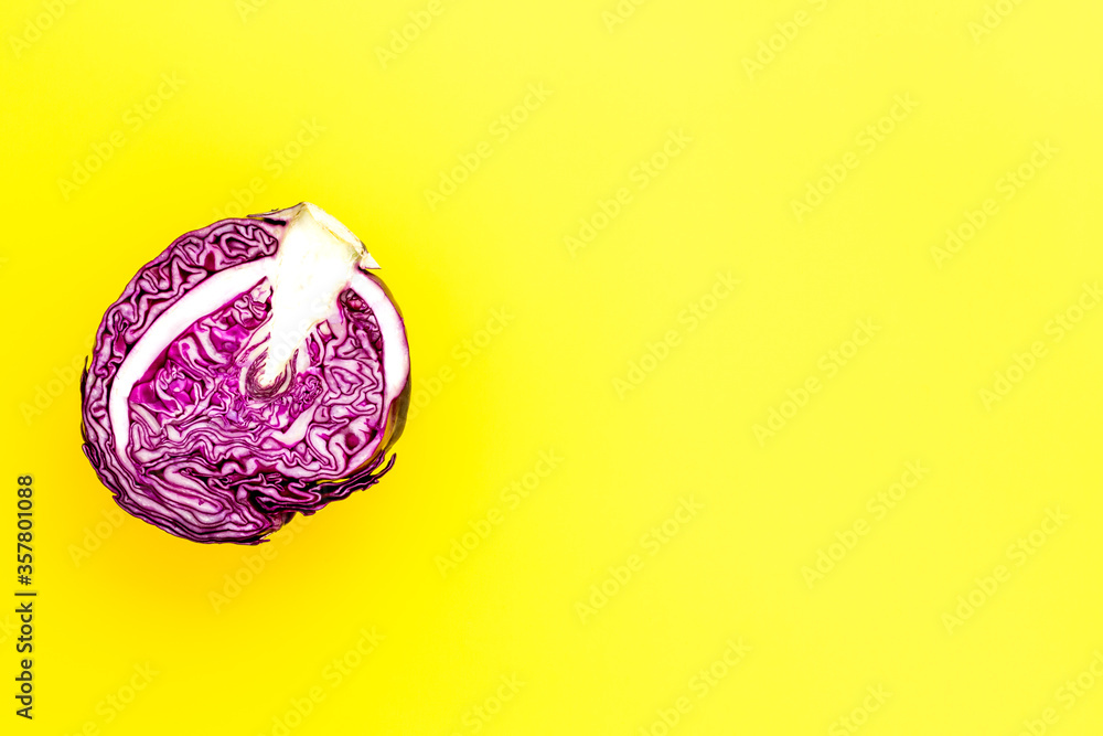 Red cabbage - head, cross section - on yellow background top view copy space