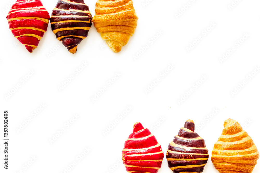 Frame of croissants - fresh bakery on white background. Top view