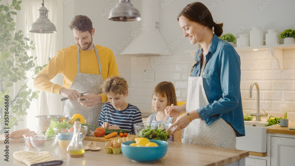 In Kitchen: Family of Four Cooking Together Healthy Dinner. Mother, Father, Little Boy and Girl, Pre