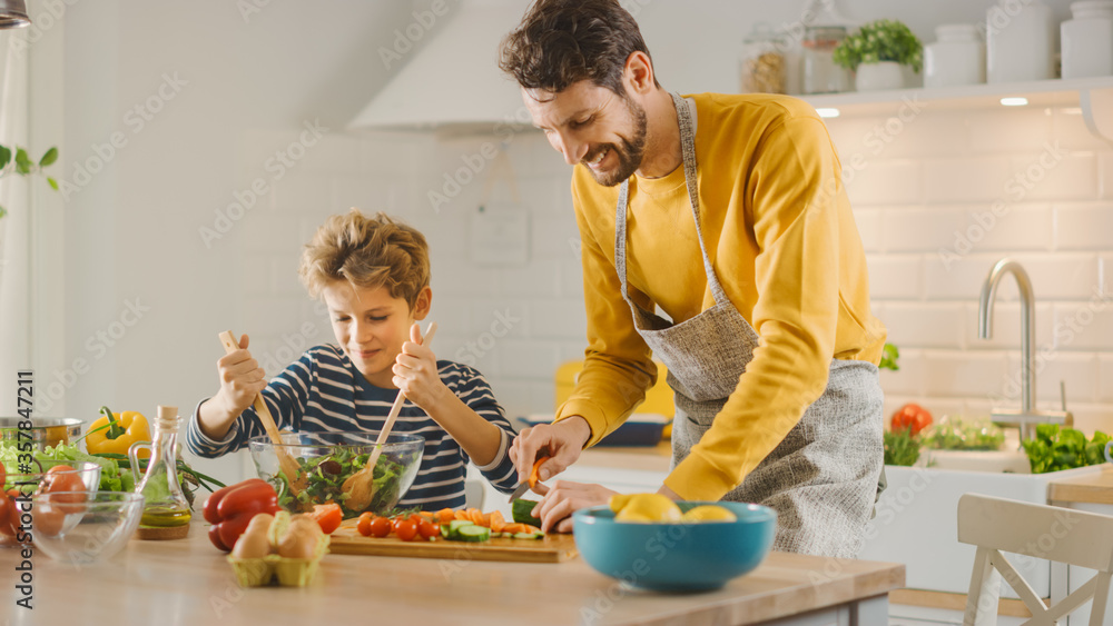 In Kitchen: Father and Cute Little Boy Cooking Together Healthy Dinner. Dad Teaches Little Son Healt