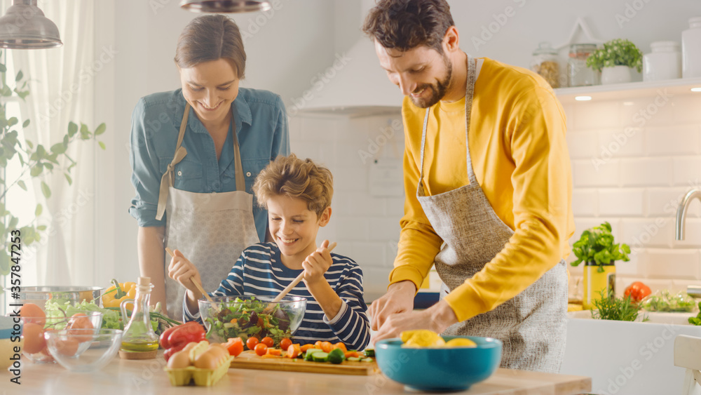 In Kitchen: Family of Three Cooking Together Healthy Dinner. Dad and Mom Teach Little Son Healthy Ha