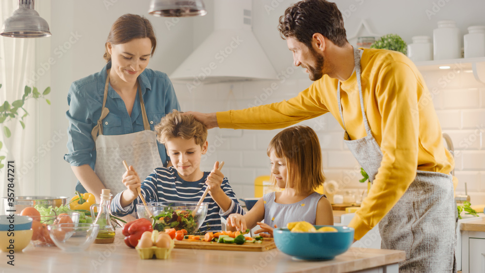 In Kitchen: Family of Four Cooking Together Healthy Dinner. Mother, Father, Little Boy and Girl, Pre