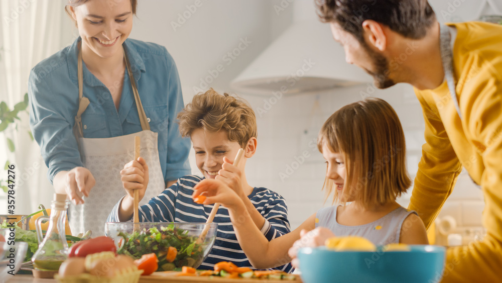 In Kitchen: Family of Four Cooking Together Healthy Dinner. Mother, Father, Little Boy and Girl, Pre