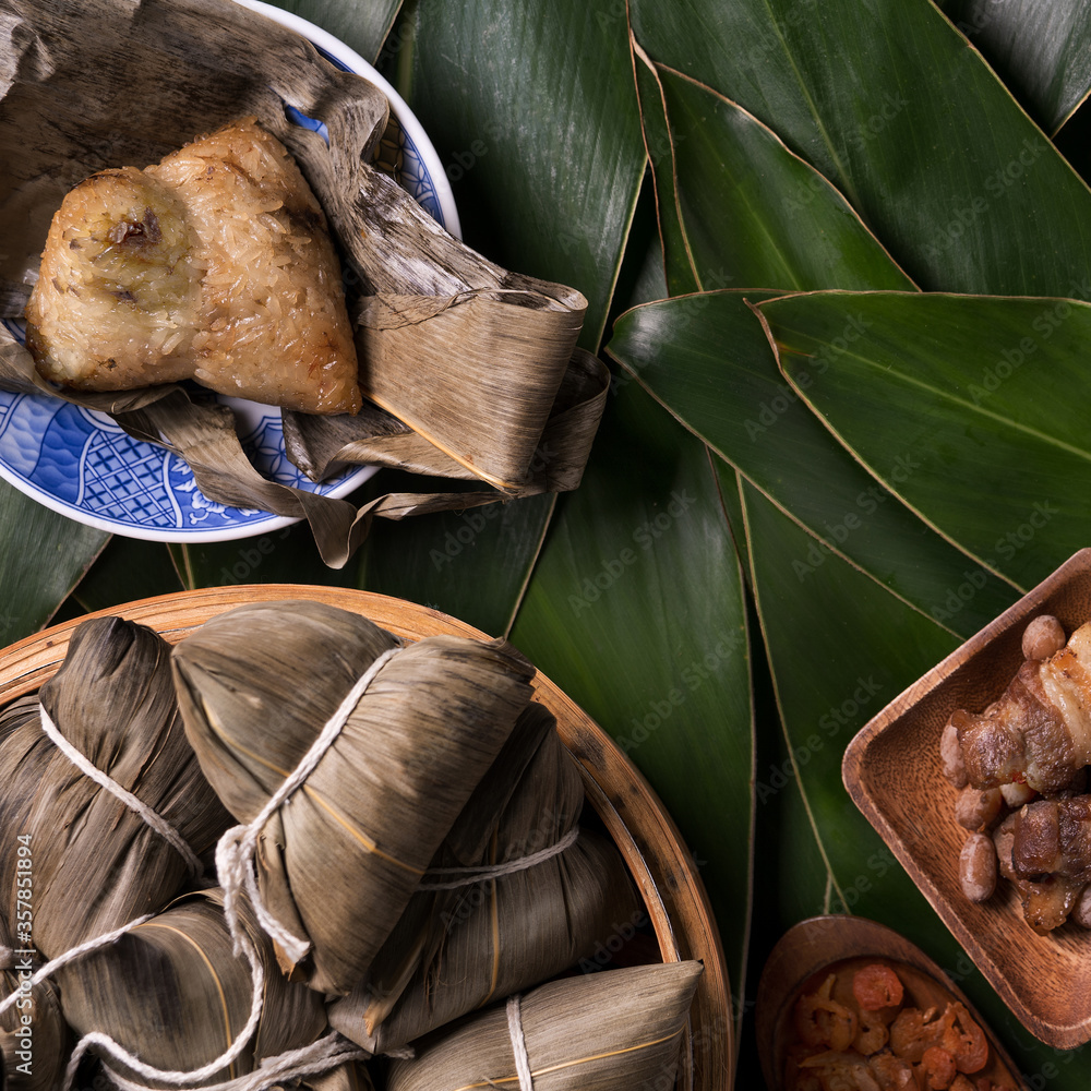 Rice dumpling, zongzi - Traditional Chinese food on green leaf background of Dragon Boat Festival, D