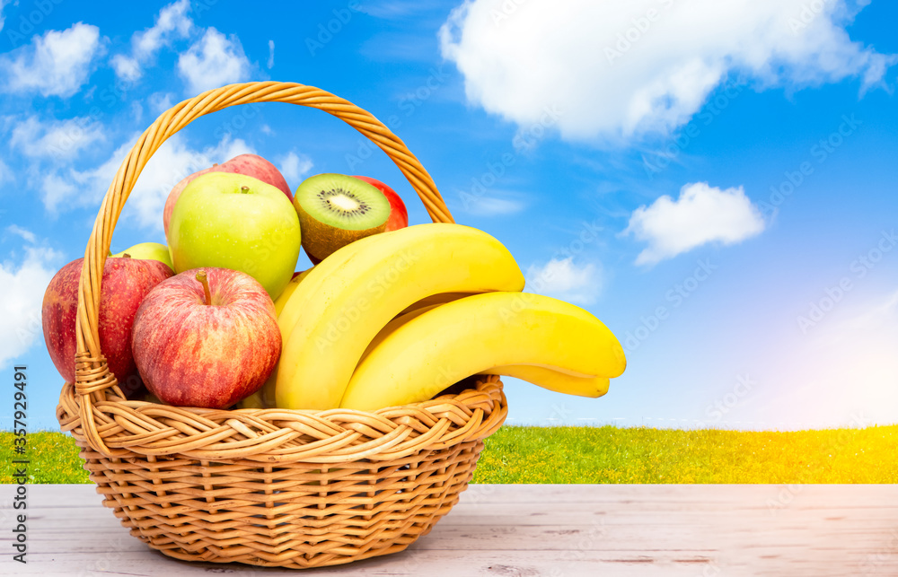 Group Healthy fresh fruit in a wooden basket, With vitamins c from bananas, kiwi, grapes, raspberrie