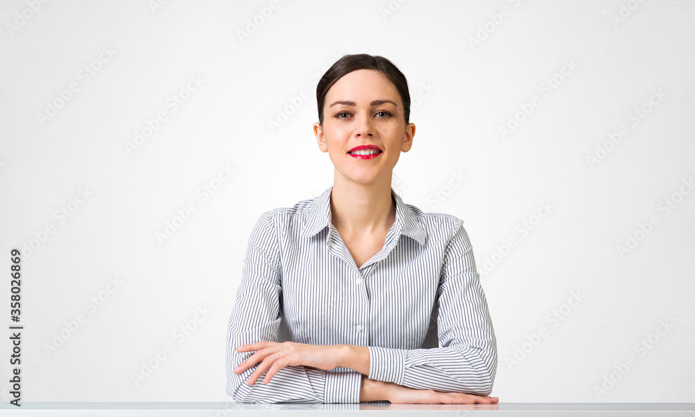 Smiling businesswoman sitting at desk