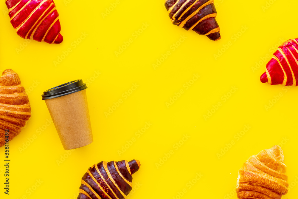 Frame of croissants - fresh bakery on yellow background. Top view