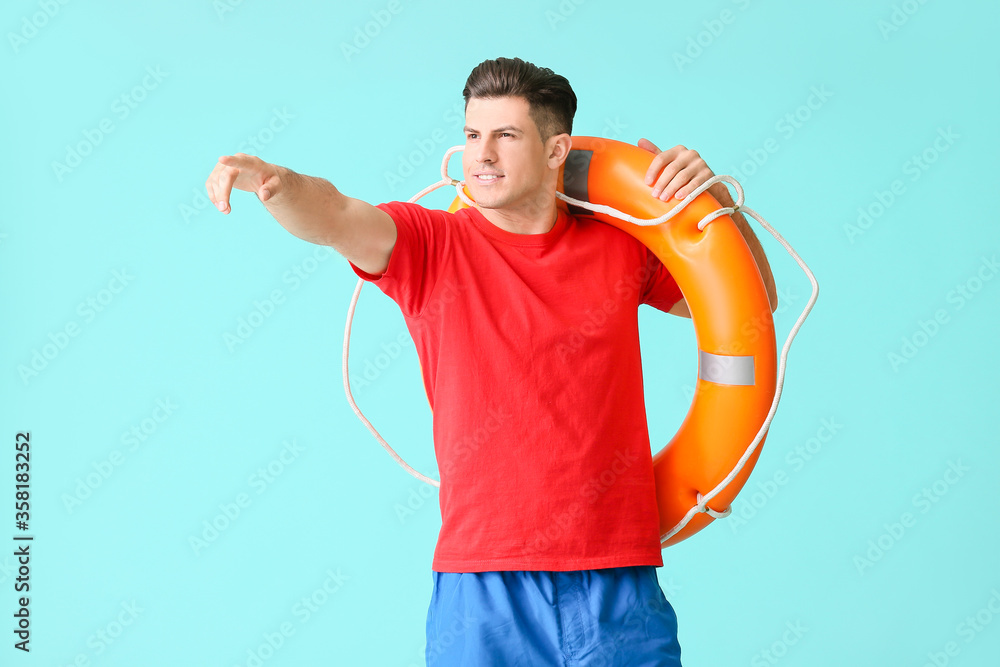 Beach rescuer with lifebuoy on color background