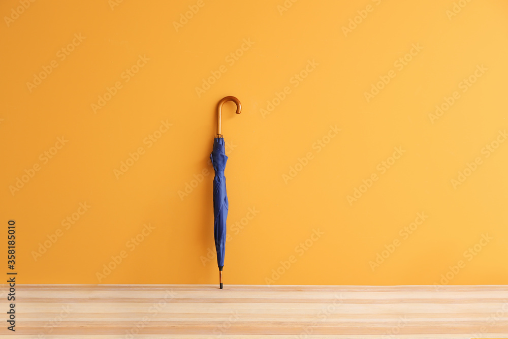 Stylish umbrella on color background