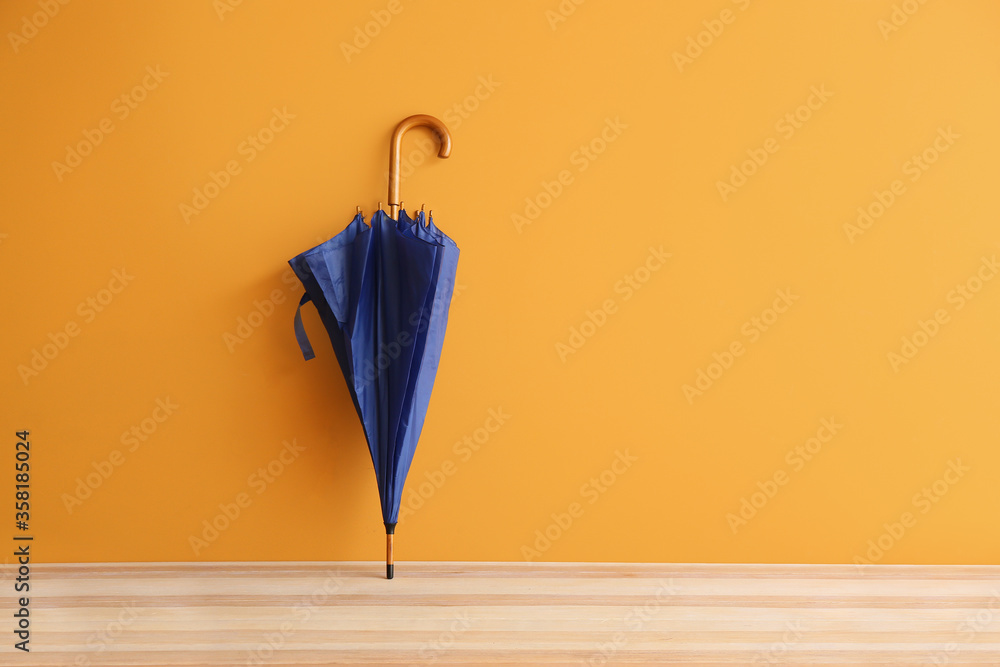 Stylish umbrella on color background