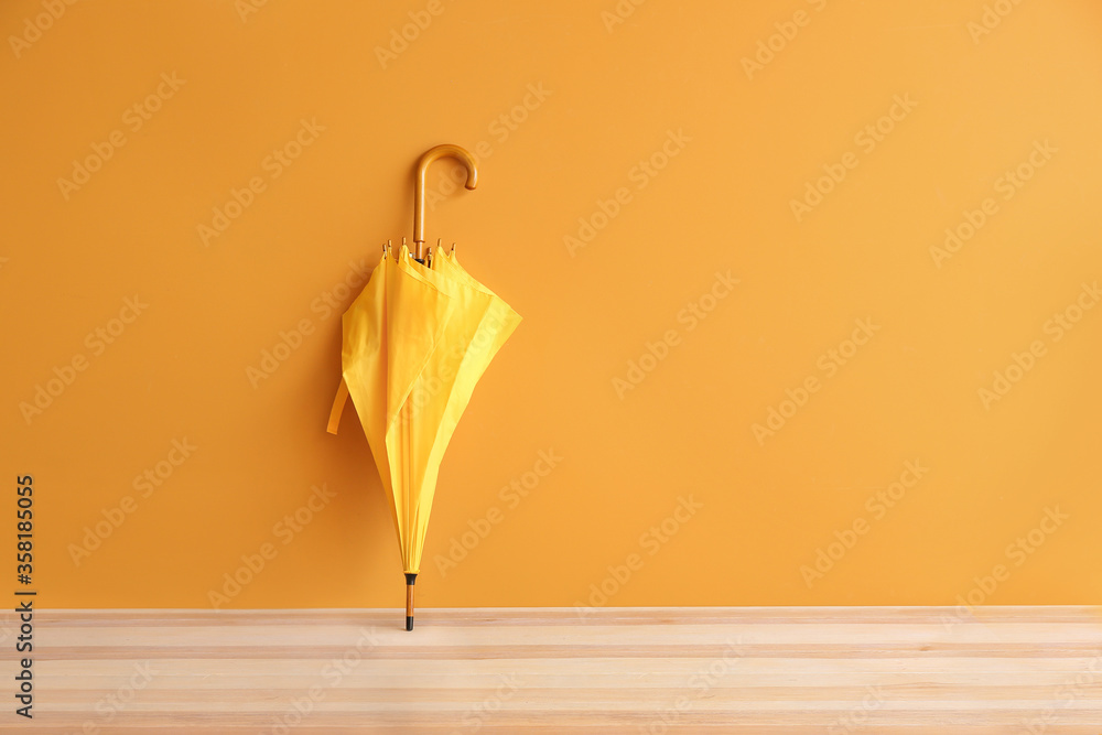 Stylish umbrella on color background