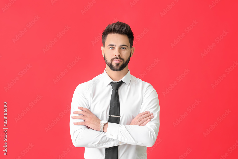 Young man in formal clothes on color background