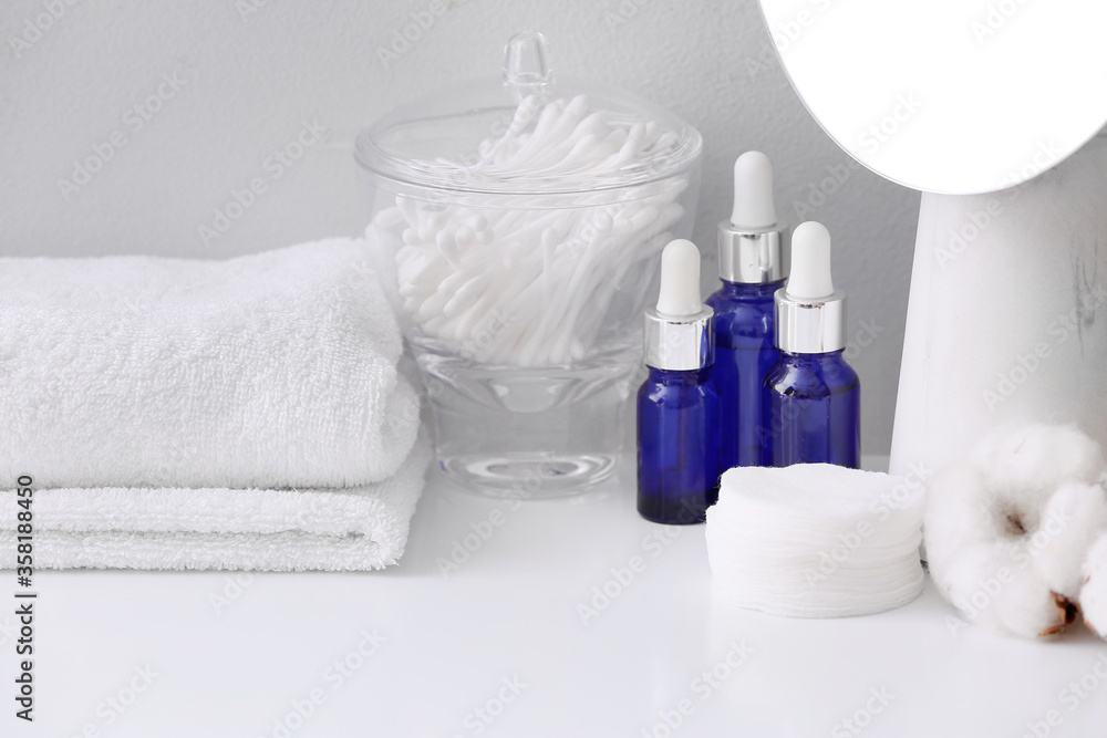 Cosmetics and supplies on table in bathroom