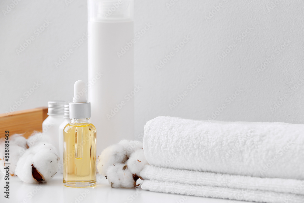 Cosmetics with cotton towels on table