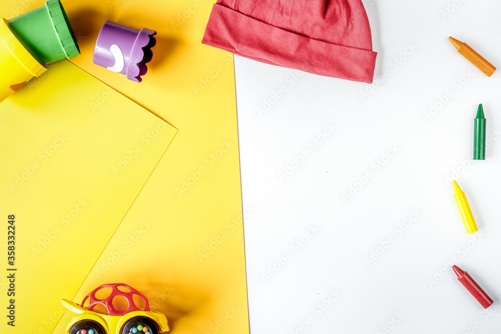 kids desk design with toys and clothes yellow white background top view mockup