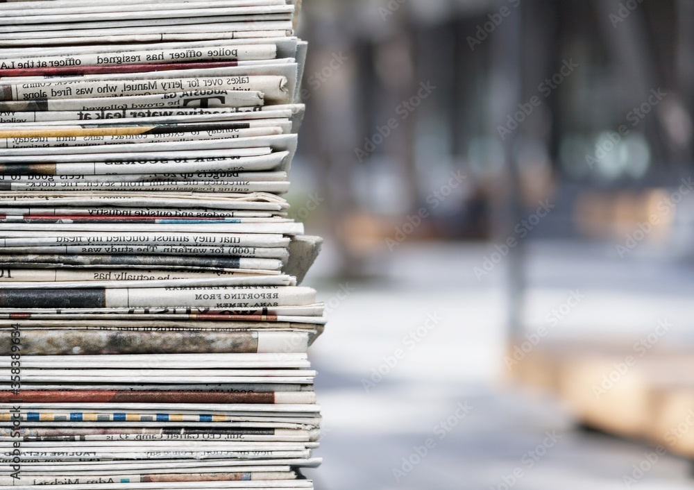 Pile of fresh newspapers on a blur background