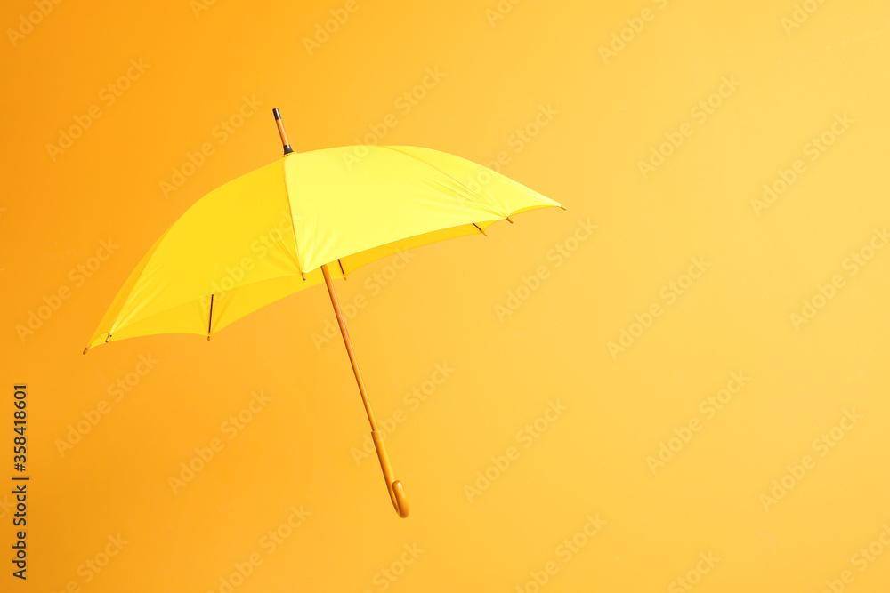 Stylish umbrella on color background