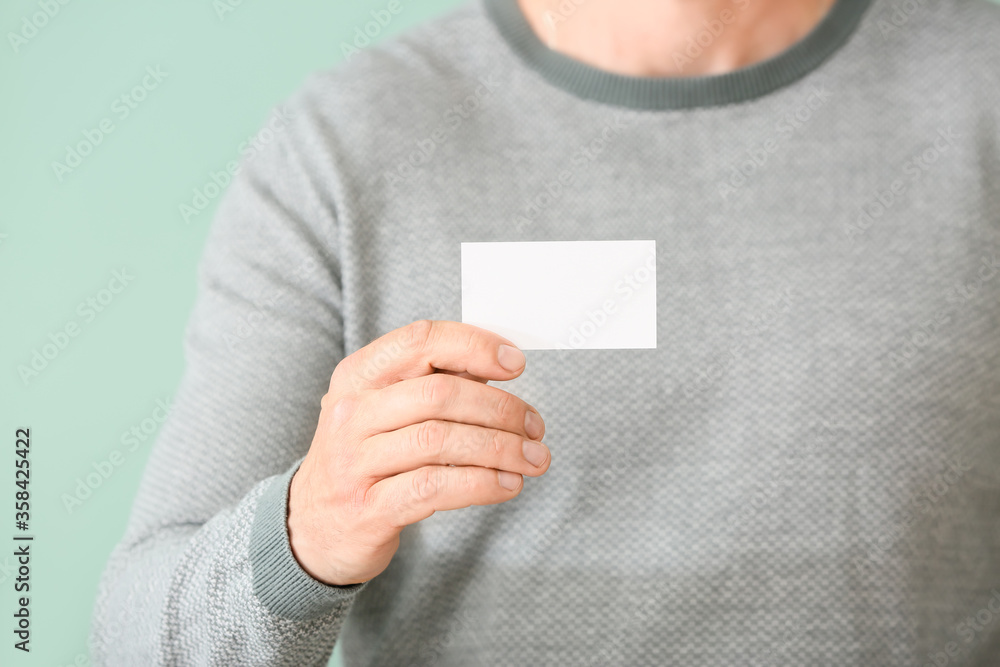 Man with blank business card, closeup