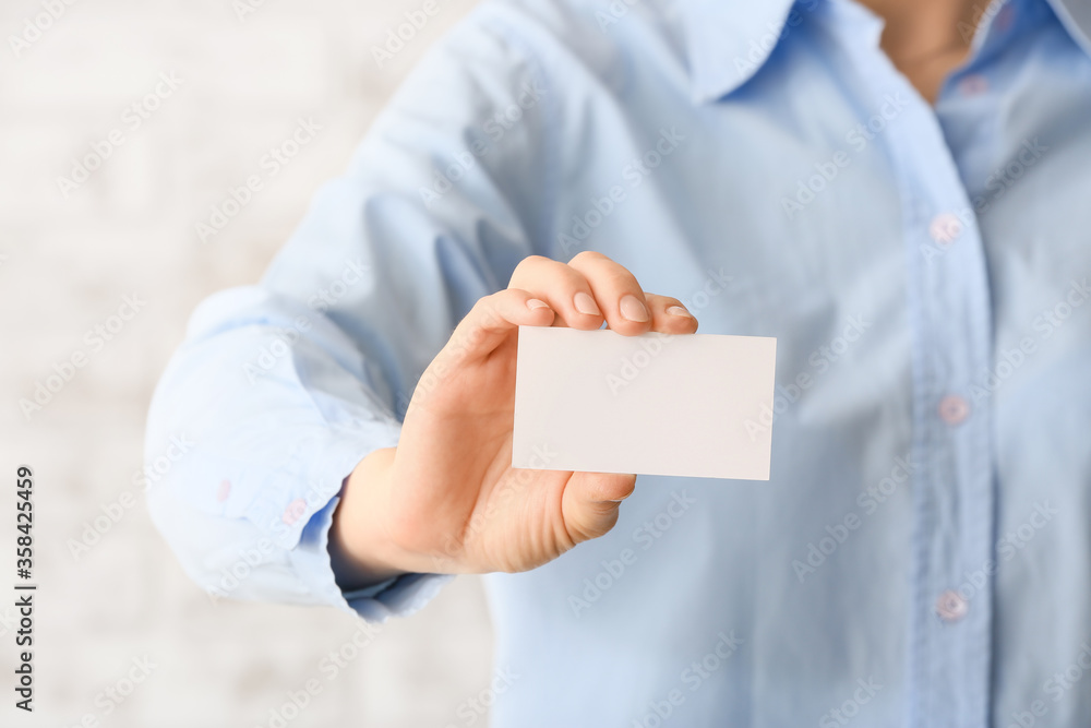 Woman with blank business card, closeup