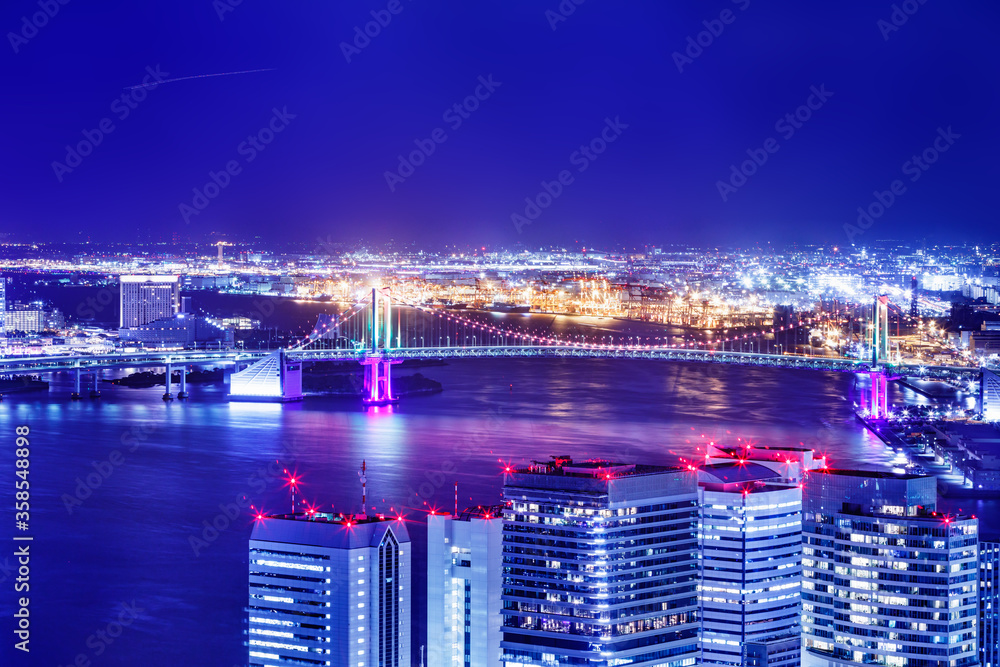 光が眩しい、東京の水辺に立ち並ぶ高層ビル群の夜景